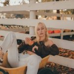 Utility Cart - Young Blonde Woman in White Jeans and Brown Blouse Sitting in a Garden Utility Cart
