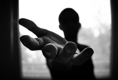 Help - Man's Hand in Shallow Focus and Grayscale Photography