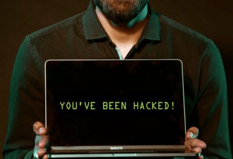 Hacks - Man Holding Laptop Computer With Both Hands