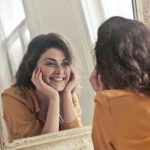Vanity - Photo of Woman Looking at the Mirror