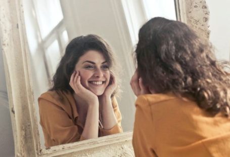 Vanity - Photo of Woman Looking at the Mirror